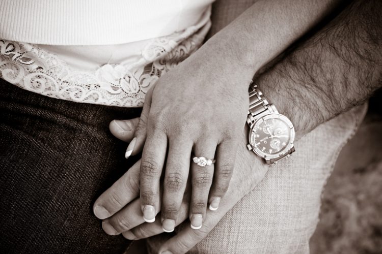 engagement ring and couple's hands