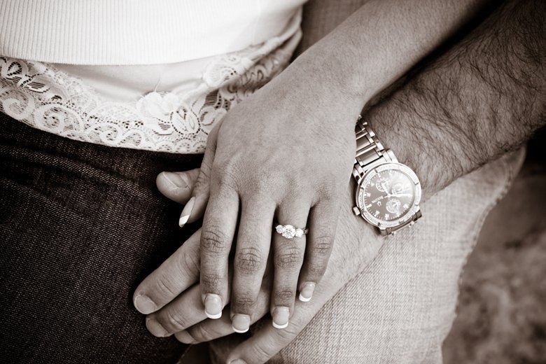 engagement ring and couple's hands