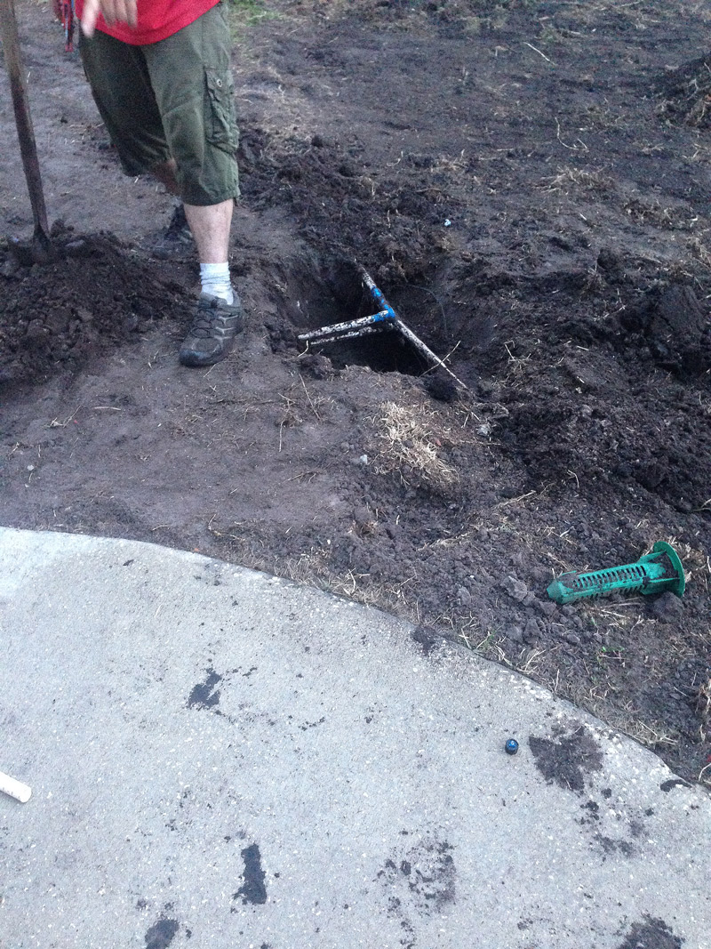 repairing irrigation pipe during sod installation