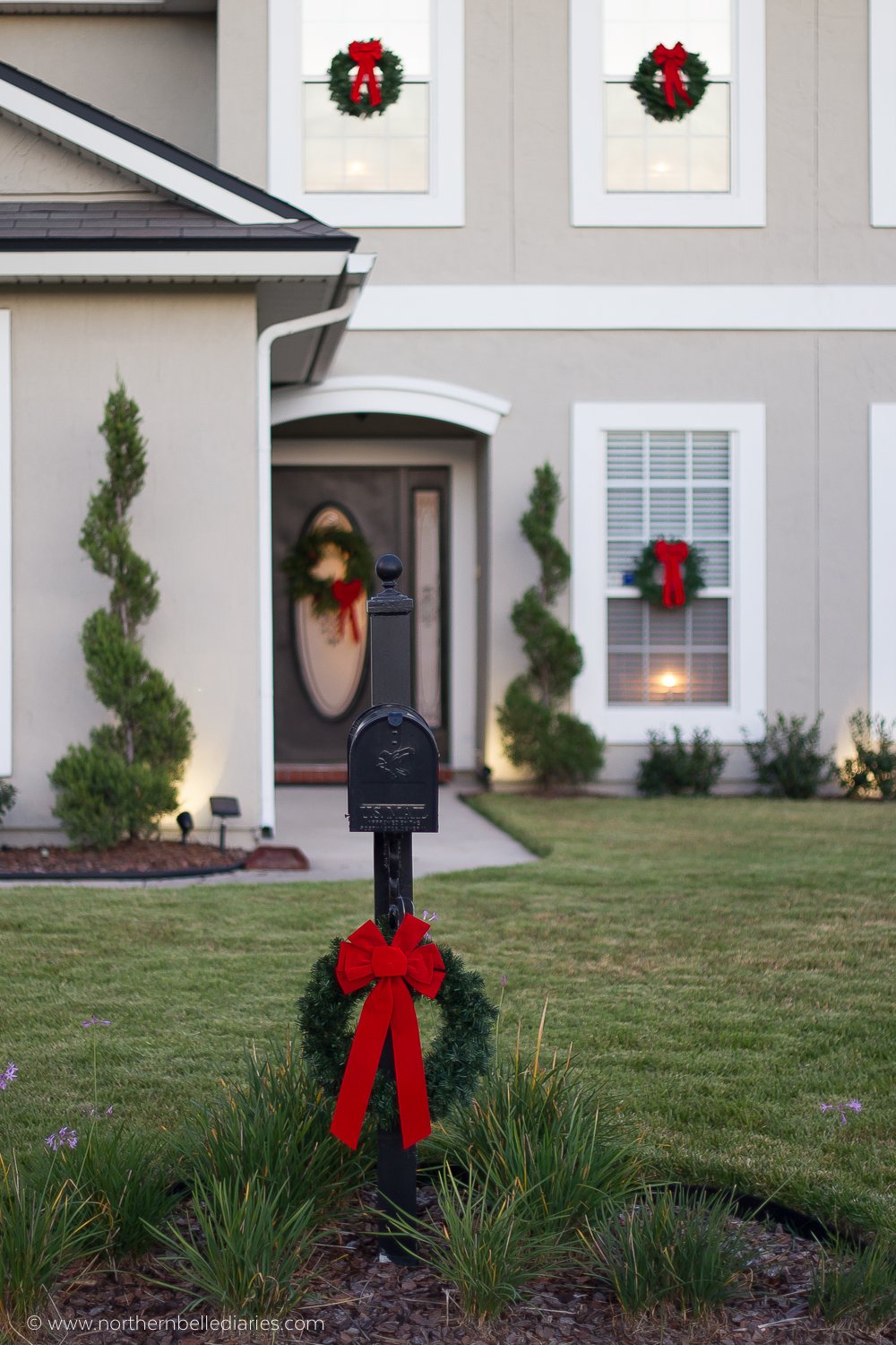 Classic Christmas wreaths with red ribbon on windows and mailbox post #christmas