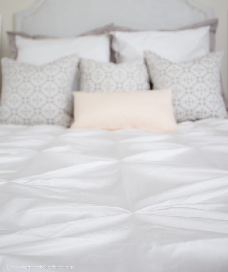 Gorgeous white and grey bedroom with a soft touch of pink. Duvet from Crane and Canopy