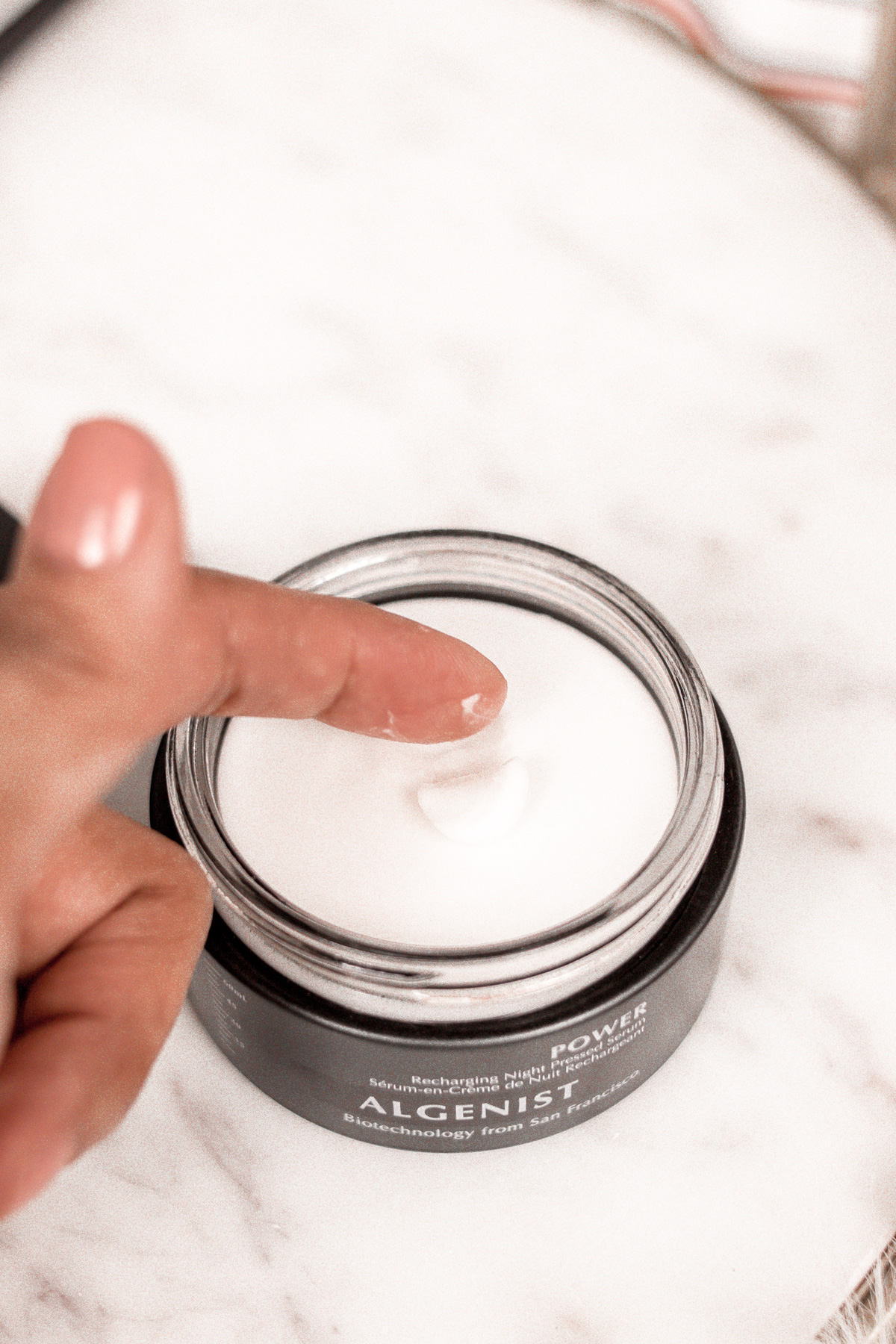 Demonstrating how the Algenist Pressed Serum is a solid