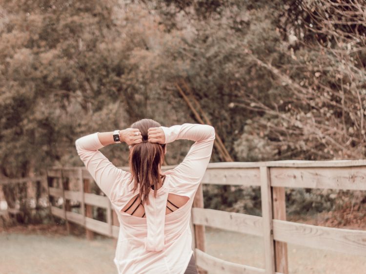 woman facing away tightening her hair tie