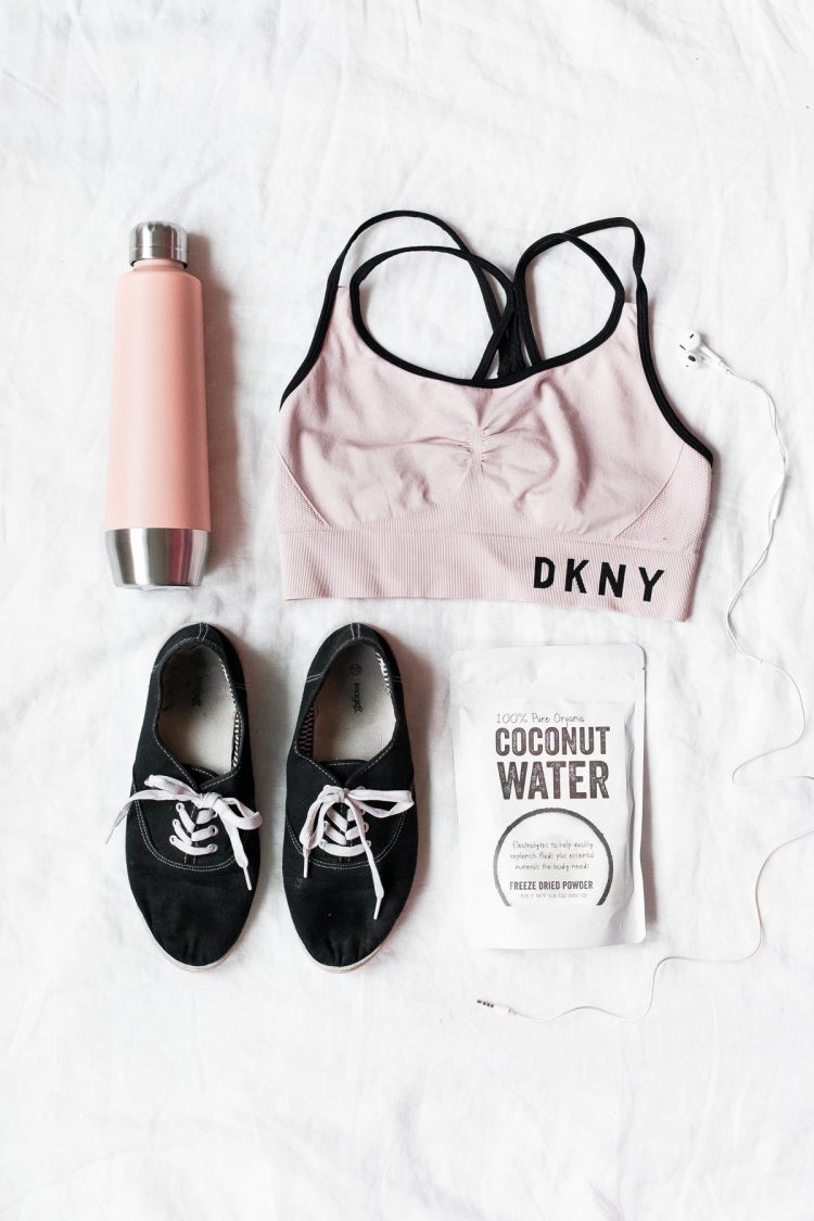 pink fitness clothing, shoes, and water bottle