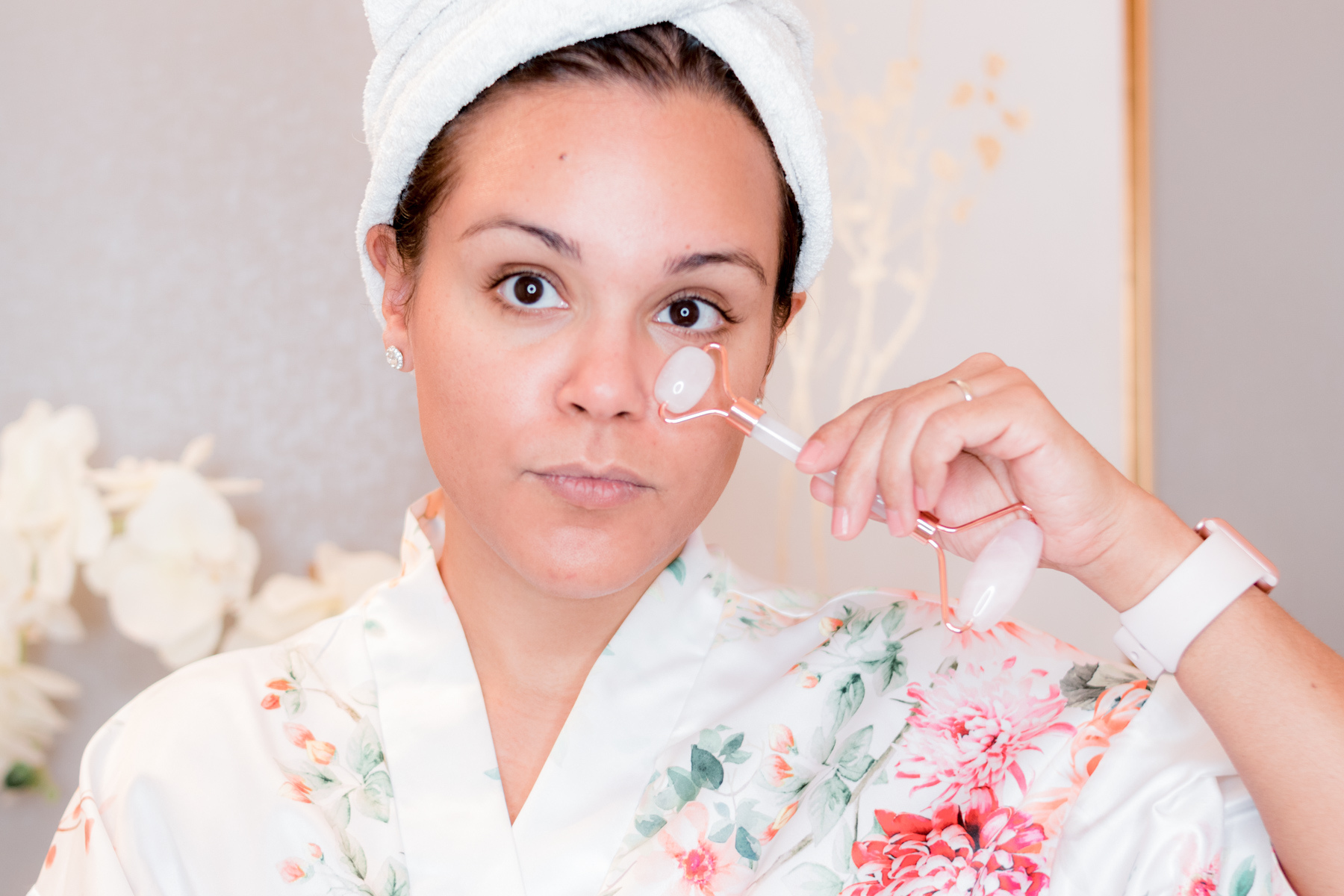 woman using rose quartz roller