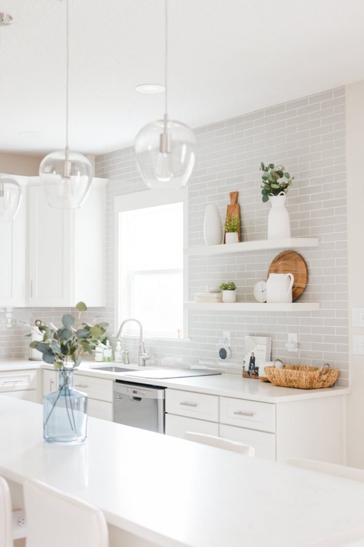 white shaker kitchen with gray subway tiles and open shelves